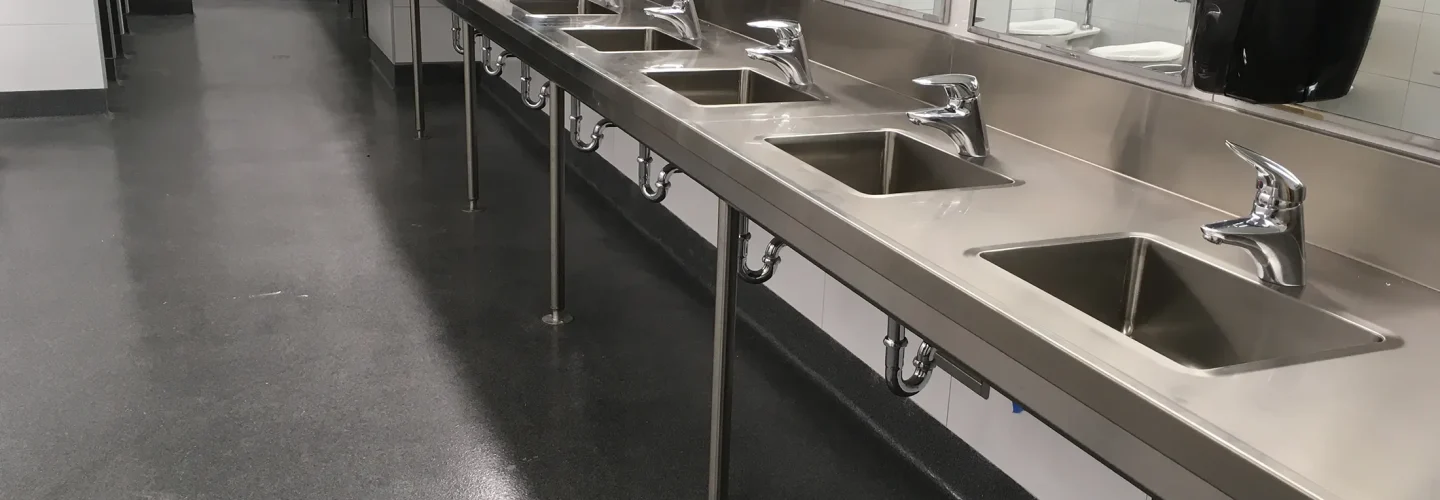 Stainless steel sinks and countertops in a bathroom